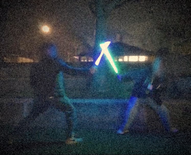A lightsaber duel at night